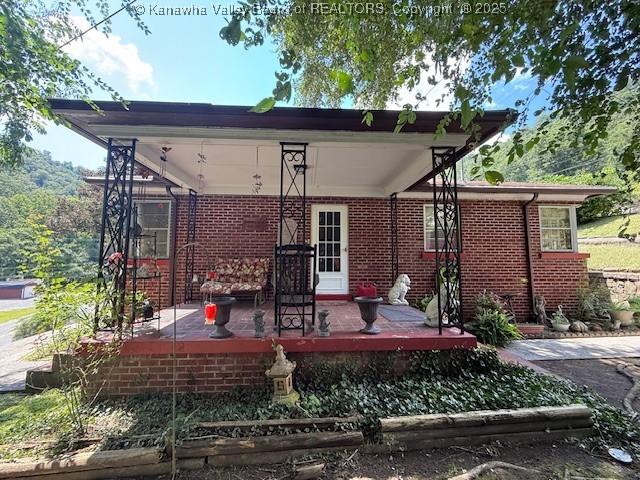 1022 Riverside Dr, Welch, WV 24801 - rear view of property featuring brick siding