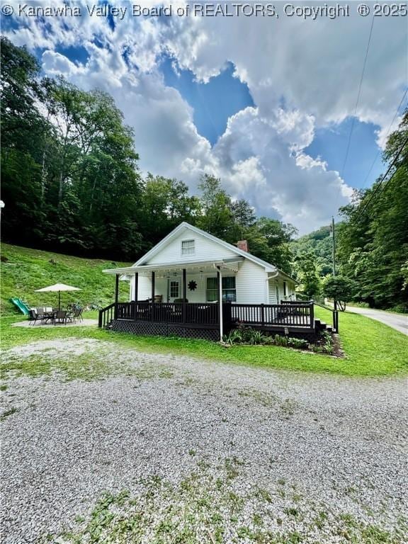 28 Brushy Frk, Alkol, WV 25501 - view of front of house with a front yard, a chimney, a deck, and an outdoor fire pit