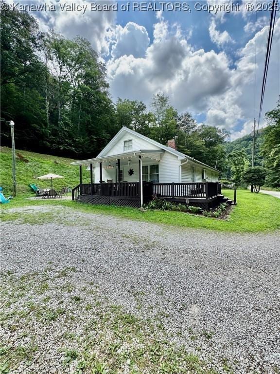 28 Brushy Frk, Alkol, WV 25501 - view of front of property with a chimney, a front lawn, and a deck