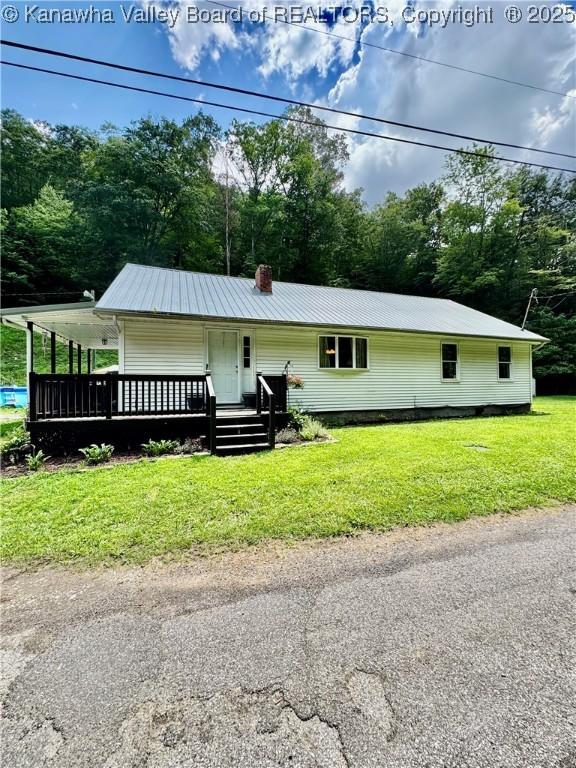 28 Brushy Frk, Alkol, WV 25501 - view of front of house with a front yard, a chimney, a porch, and a metal roof