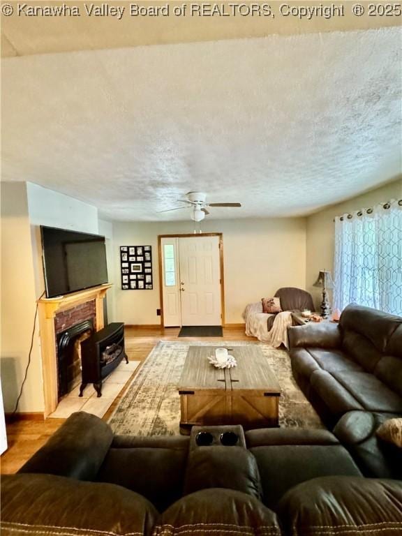 28 Brushy Frk, Alkol, WV 25501 - living area featuring ceiling fan, light wood finished floors, and a brick fireplace