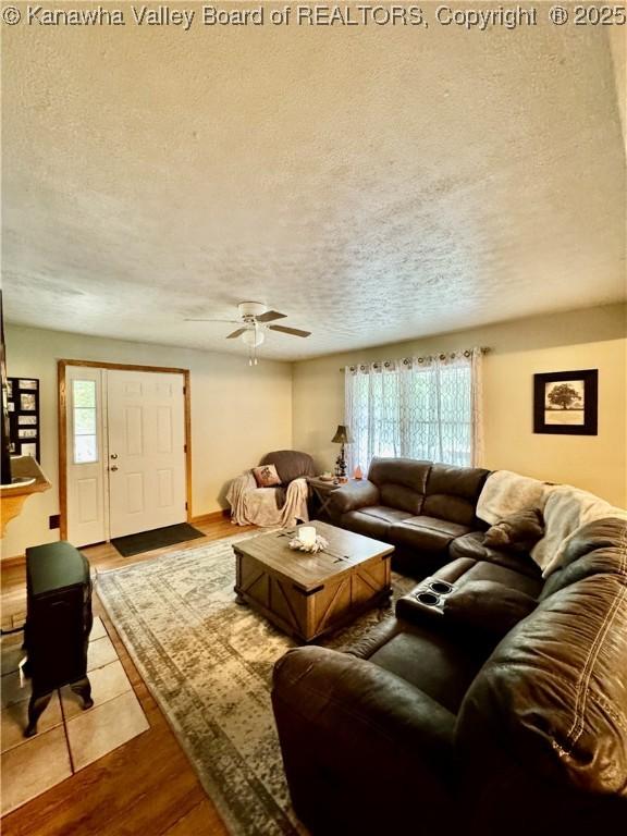 28 Brushy Frk, Alkol, WV 25501 - living room featuring a textured ceiling, wood finished floors, and a ceiling fan