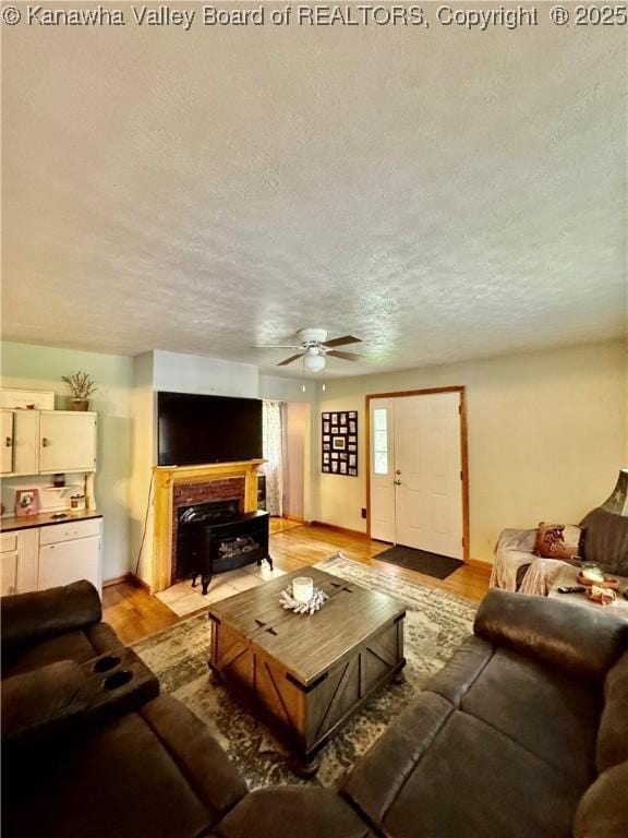 28 Brushy Frk, Alkol, WV 25501 - living area featuring a textured ceiling, ceiling fan, and light wood-style floors