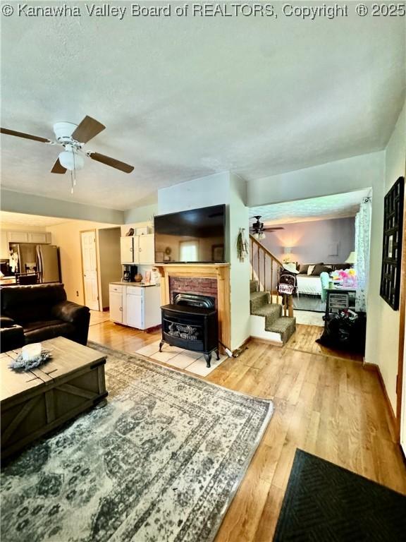 28 Brushy Frk, Alkol, WV 25501 - living room with a ceiling fan, stairs, and light wood-style floors