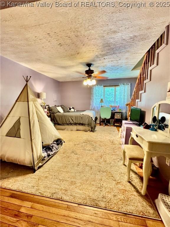 28 Brushy Frk, Alkol, WV 25501 - bedroom with a textured ceiling, wood finished floors, and ceiling fan