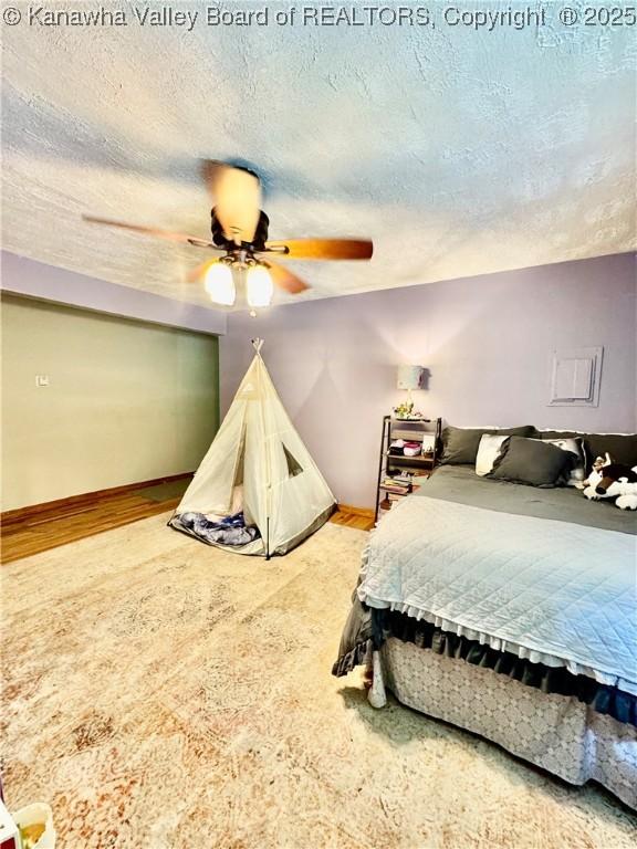 28 Brushy Frk, Alkol, WV 25501 - bedroom with ceiling fan, a textured ceiling, and wood finished floors