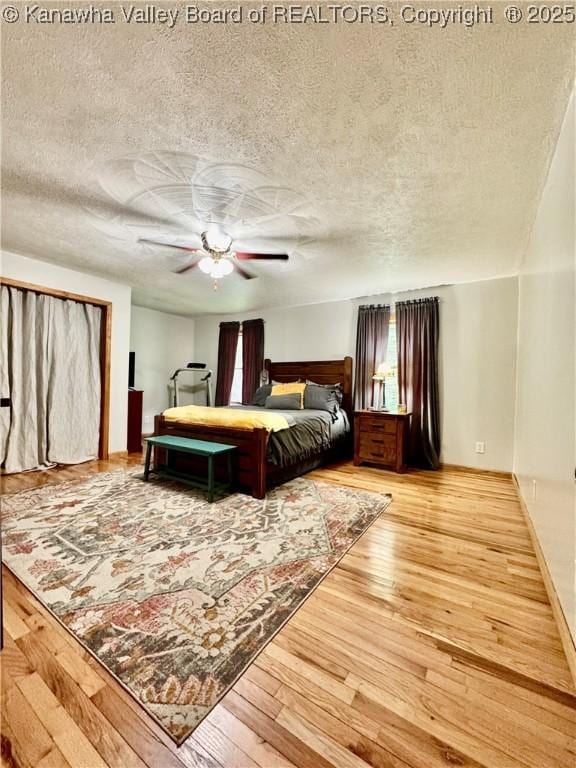 28 Brushy Frk, Alkol, WV 25501 - bedroom with wood-type flooring, a textured ceiling, and ceiling fan