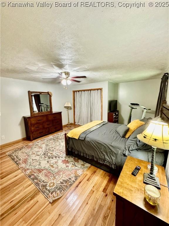 28 Brushy Frk, Alkol, WV 25501 - bedroom with a textured ceiling, wood finished floors, and ceiling fan