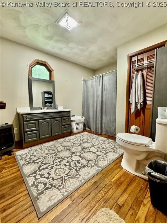 28 Brushy Frk, Alkol, WV 25501 - full bath with wood finished floors, curtained shower, and vanity