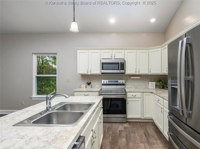 6 Squires Dr, Saint Albans, WV 25177 - kitchen with appliances with stainless steel finishes, dark wood-type flooring, light countertops, white cabinets, and recessed lighting