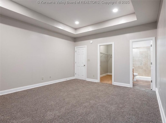 6 Squires Dr, Saint Albans, WV 25177 - unfurnished bedroom featuring carpet floors, a tray ceiling, a walk in closet, connected bathroom, and recessed lighting