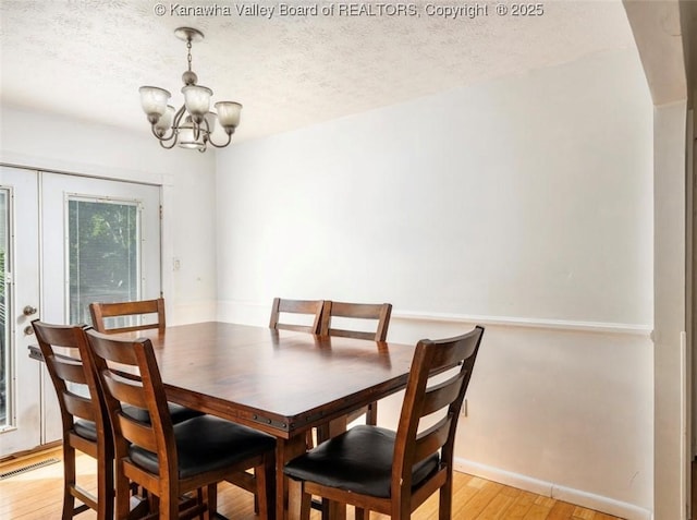 105 Lincoln Hts, Alum Creek, WV 25003 - dining space featuring a chandelier, light wood-style floors, and a textured ceiling