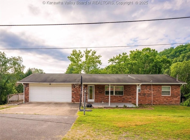 105 Lincoln Hts, Alum Creek, WV 25003 - ranch-style house with brick siding, concrete driveway, an attached garage, and a front lawn