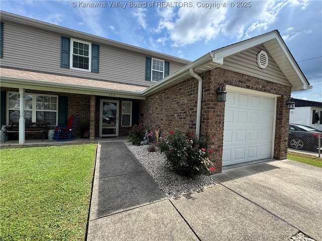 2314 Harrison Ave, Saint Albans, WV 25177 - traditional home with a garage, driveway, a front lawn, and brick siding