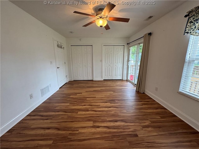 2314 Harrison Ave, Saint Albans, WV 25177 - unfurnished bedroom featuring dark wood finished floors, two closets, and ceiling fan