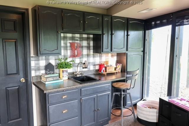 282 Dupont Rd, Poca, WV 25159 - kitchen with dark countertops, decorative backsplash, and dark wood finished floors