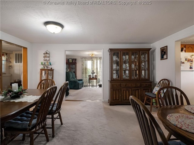 4728 Cain Ridge Rd, Leon, WV 25123 - dining room with light carpet and a textured ceiling