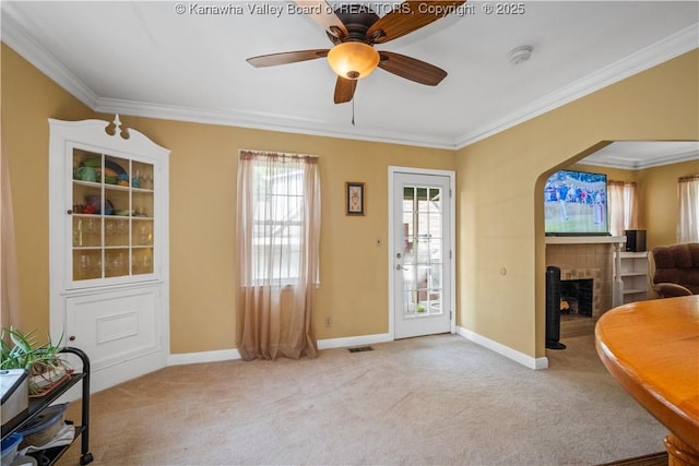 2526 Spring St, South Charleston, WV 25303 - carpeted foyer entrance with ceiling fan, ornamental molding, a fireplace, and arched walkways