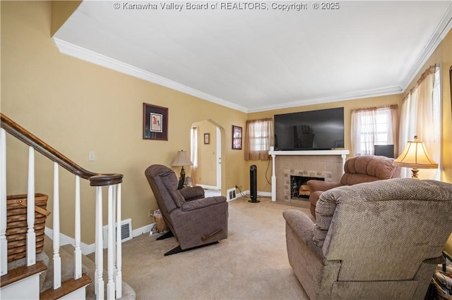 2526 Spring St, South Charleston, WV 25303 - living area featuring arched walkways, light colored carpet, crown molding, healthy amount of natural light, and a fireplace