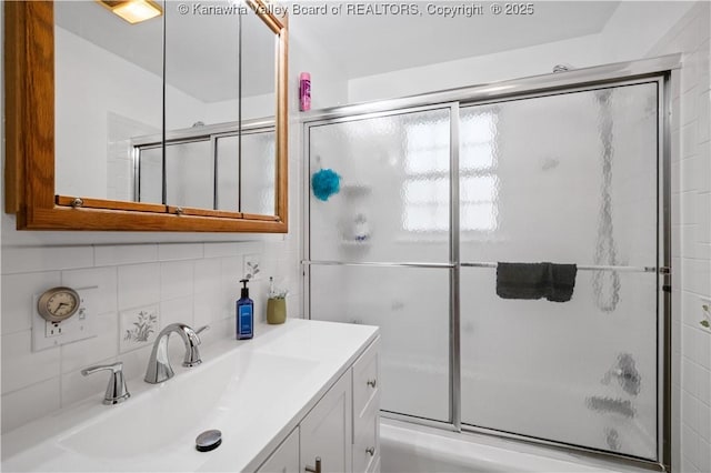 2526 Spring St, South Charleston, WV 25303 - full bathroom with vanity, backsplash, and shower / bath combination with glass door