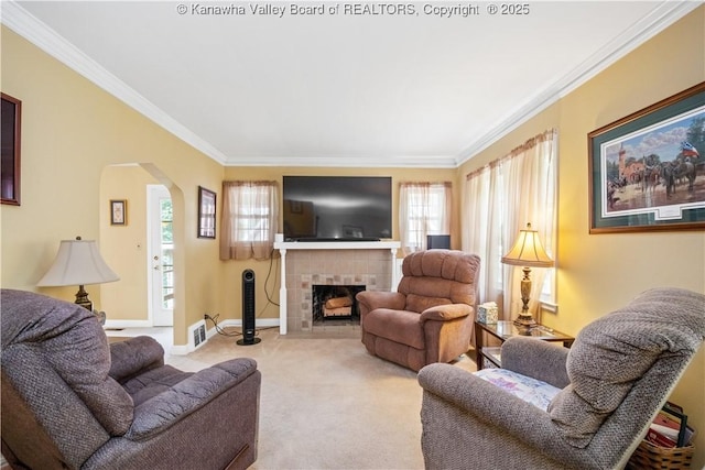 2526 Spring St, South Charleston, WV 25303 - carpeted living room featuring arched walkways, ornamental molding, and a tile fireplace