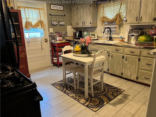 123 Valley Dr, Nitro, WV 25143 - kitchen featuring black appliances, light wood-style flooring, and light countertops