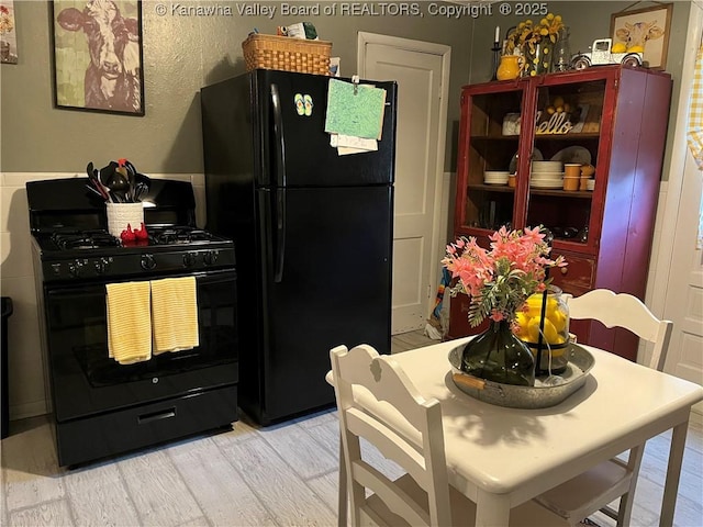 123 Valley Dr, Nitro, WV 25143 - kitchen with black appliances and light wood-type flooring