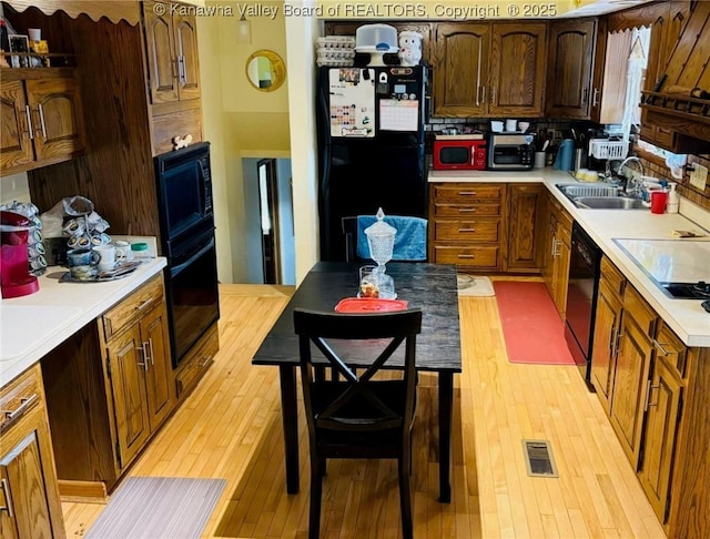 1816 Winding Hill Dr, Sissonville, WV 25320 - kitchen with black appliances, light wood-type flooring, and light countertops