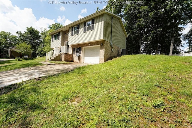 51 Beaver Dr, Hurricane, WV 25526 - raised ranch with brick siding, an attached garage, driveway, and a front yard