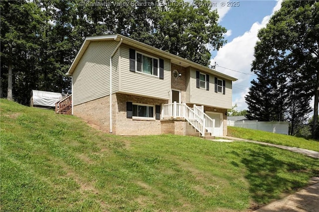 51 Beaver Dr, Hurricane, WV 25526 - bi-level home featuring brick siding, a front lawn, stairway, and an attached garage