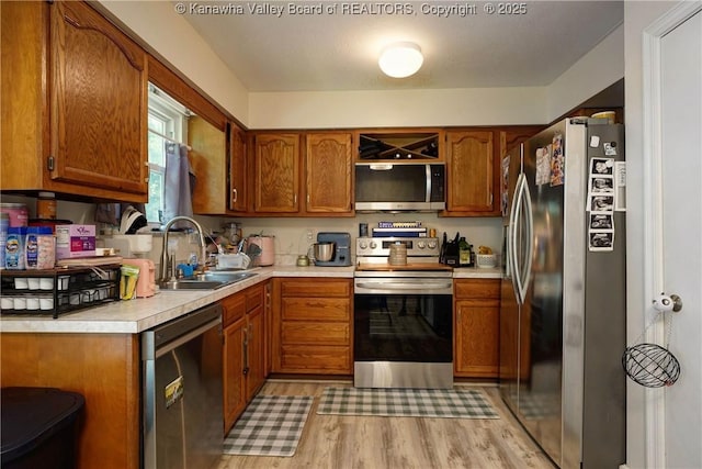 51 Beaver Dr, Hurricane, WV 25526 - kitchen with appliances with stainless steel finishes, brown cabinets, light countertops, and light wood-type flooring
