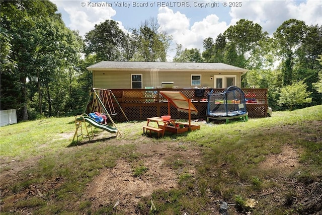 51 Beaver Dr, Hurricane, WV 25526 - back of property with a deck, a playground, and a lawn