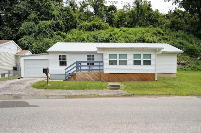 1009 Midway Dr, Dunbar, WV 25064 - view of front of home featuring a metal roof, a front lawn, asphalt driveway, and an attached garage