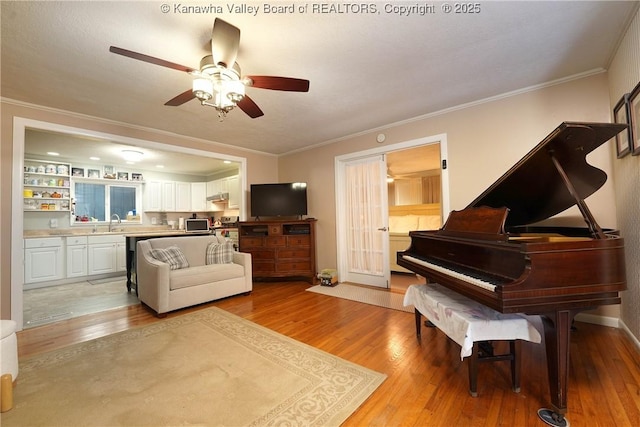 1009 Midway Dr, Dunbar, WV 25064 - living room with light wood-style floors, a ceiling fan, and crown molding
