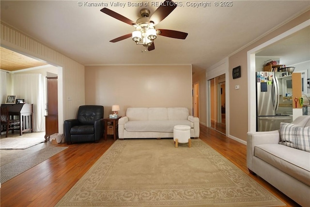 1009 Midway Dr, Dunbar, WV 25064 - living area featuring wood finished floors, a ceiling fan, and crown molding