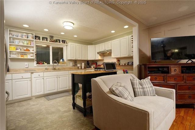 1009 Midway Dr, Dunbar, WV 25064 - kitchen featuring crown molding, white cabinetry, light countertops, recessed lighting, and under cabinet range hood
