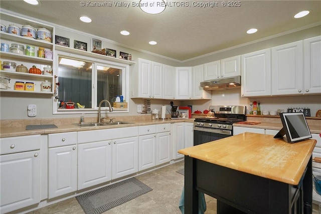 1009 Midway Dr, Dunbar, WV 25064 - kitchen featuring gas range, white cabinets, under cabinet range hood, ornamental molding, and butcher block countertops