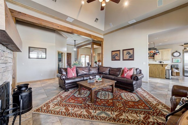 living room featuring ceiling fan, a fireplace, and high vaulted ceiling