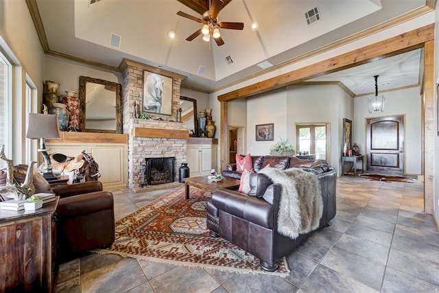 living room with a high ceiling, tile patterned floors, crown molding, a fireplace, and ceiling fan with notable chandelier