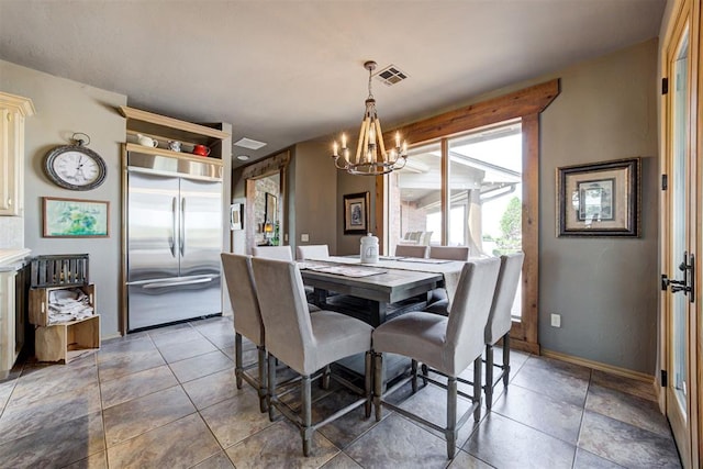 dining space with an inviting chandelier