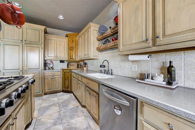 kitchen with decorative backsplash, appliances with stainless steel finishes, light tile patterned floors, and sink