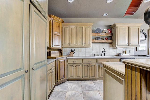 kitchen with light tile patterned floors, tasteful backsplash, and sink