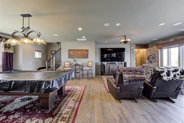 recreation room featuring light hardwood / wood-style flooring, indoor bar, and pool table