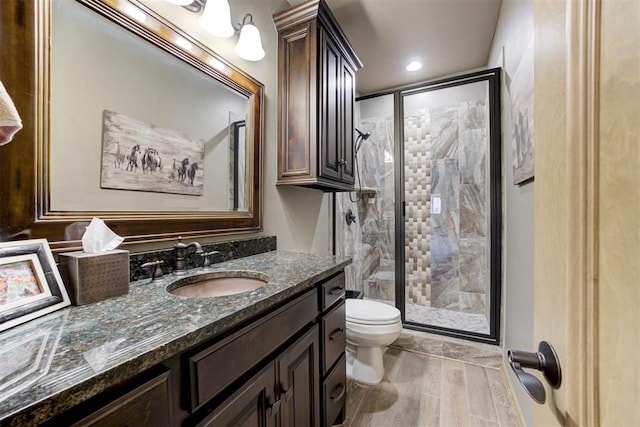 bathroom with vanity, toilet, and an enclosed shower