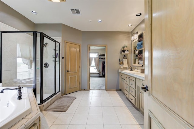 bathroom with independent shower and bath, tile patterned flooring, vanity, and a healthy amount of sunlight