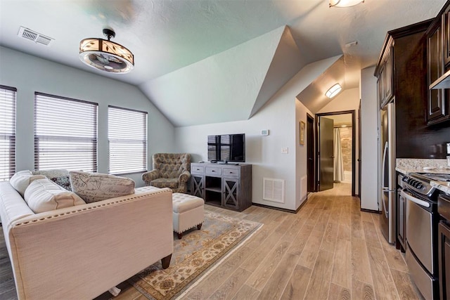 living room with lofted ceiling and light hardwood / wood-style flooring