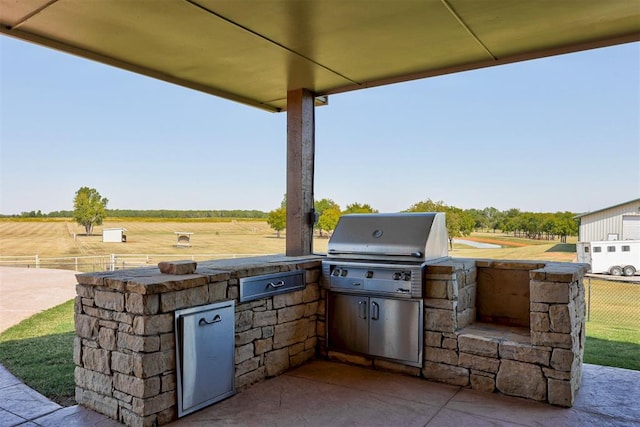 view of patio with a rural view, area for grilling, and grilling area