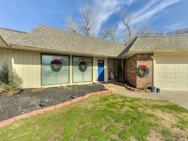 entrance to property with a yard and a garage