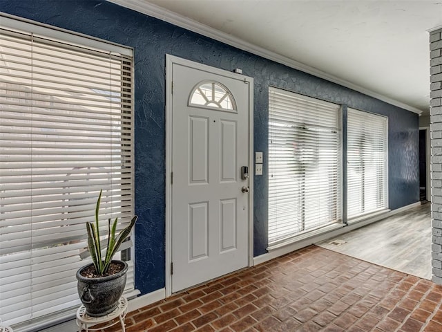 foyer featuring ornamental molding