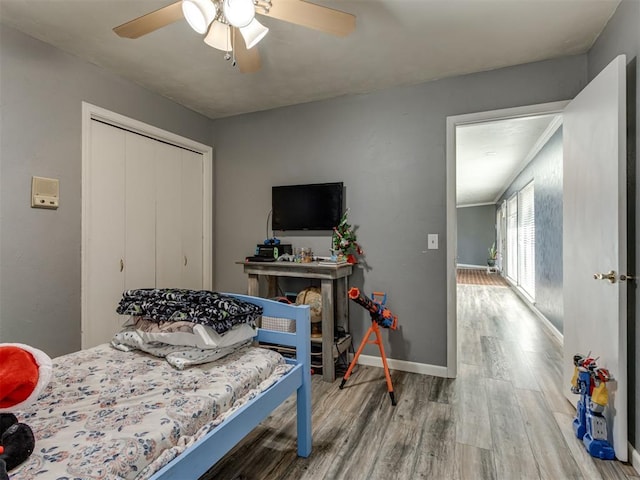 bedroom with a closet, ceiling fan, and hardwood / wood-style floors